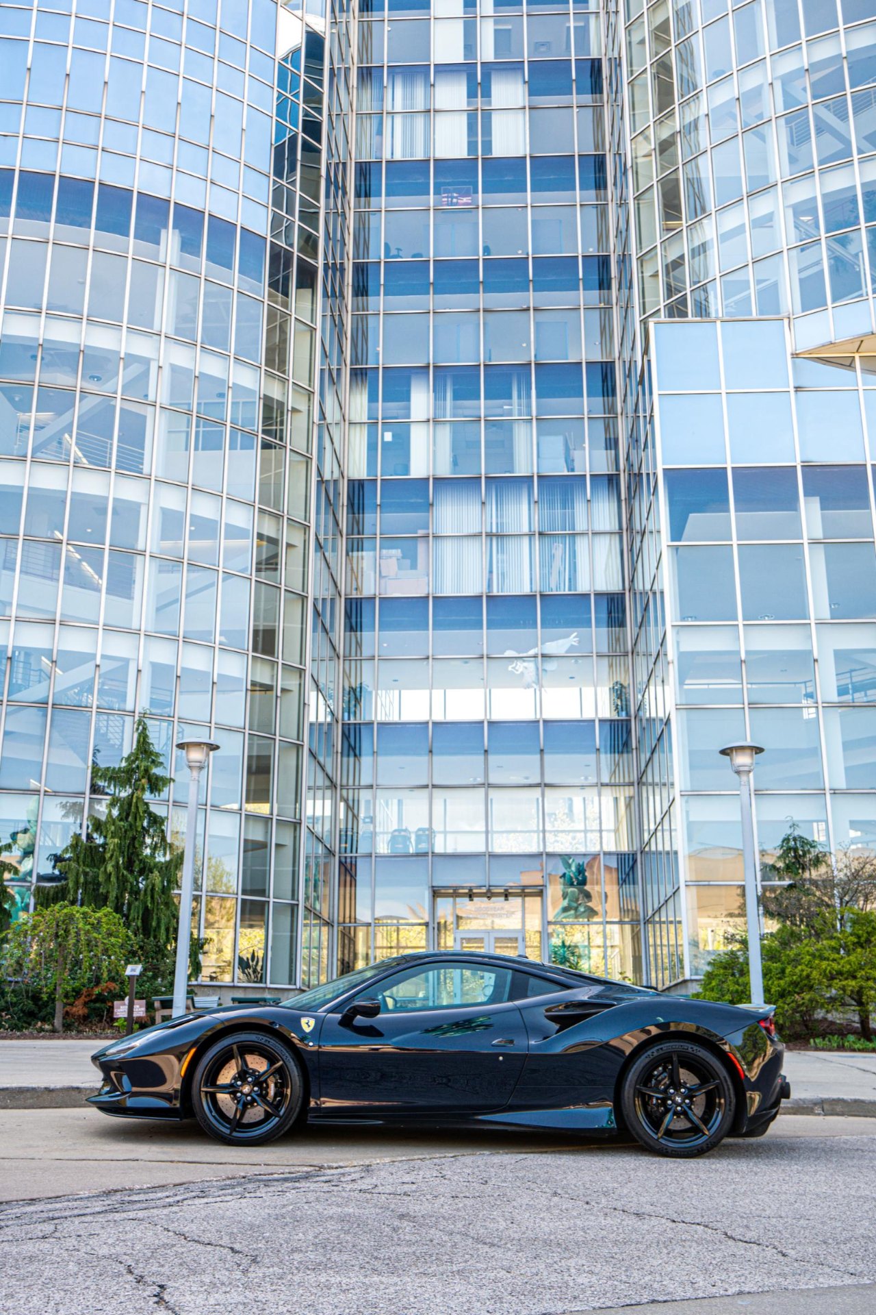 Ferrari against a glass tower